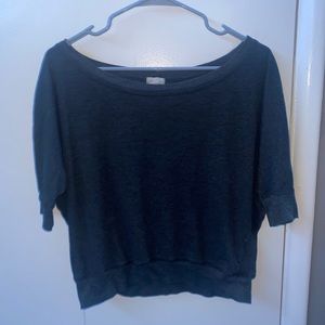 Off shoulder grey shirt.